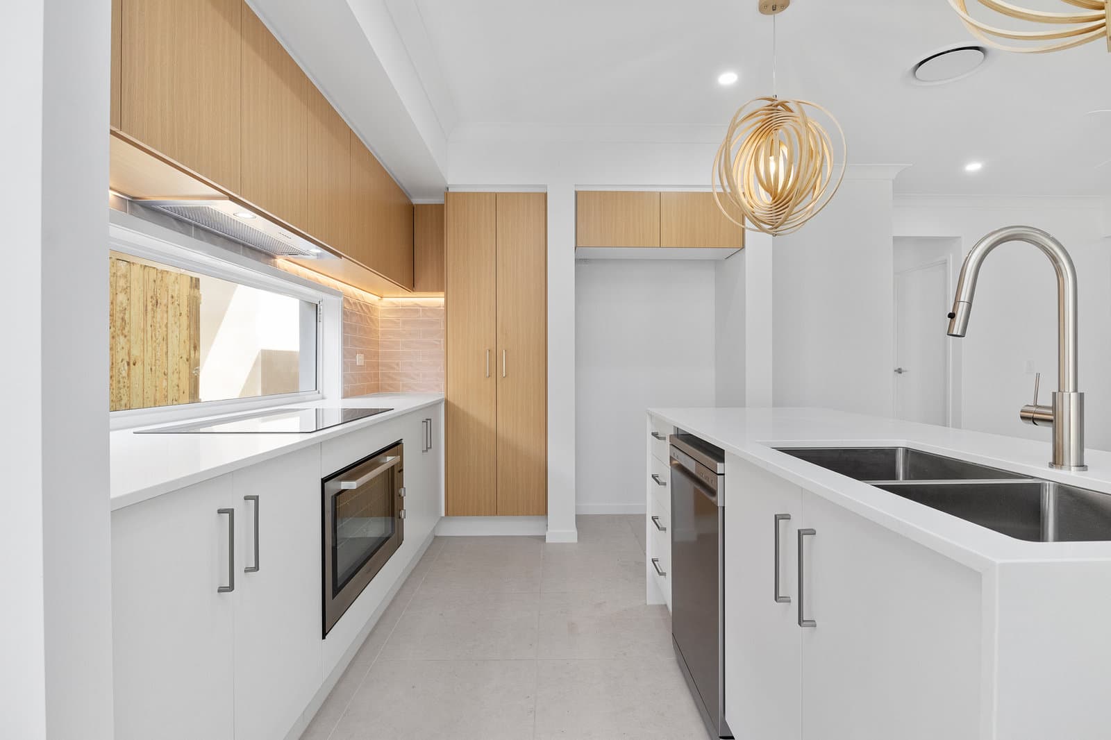 White and timber kitchen with integrated appliances