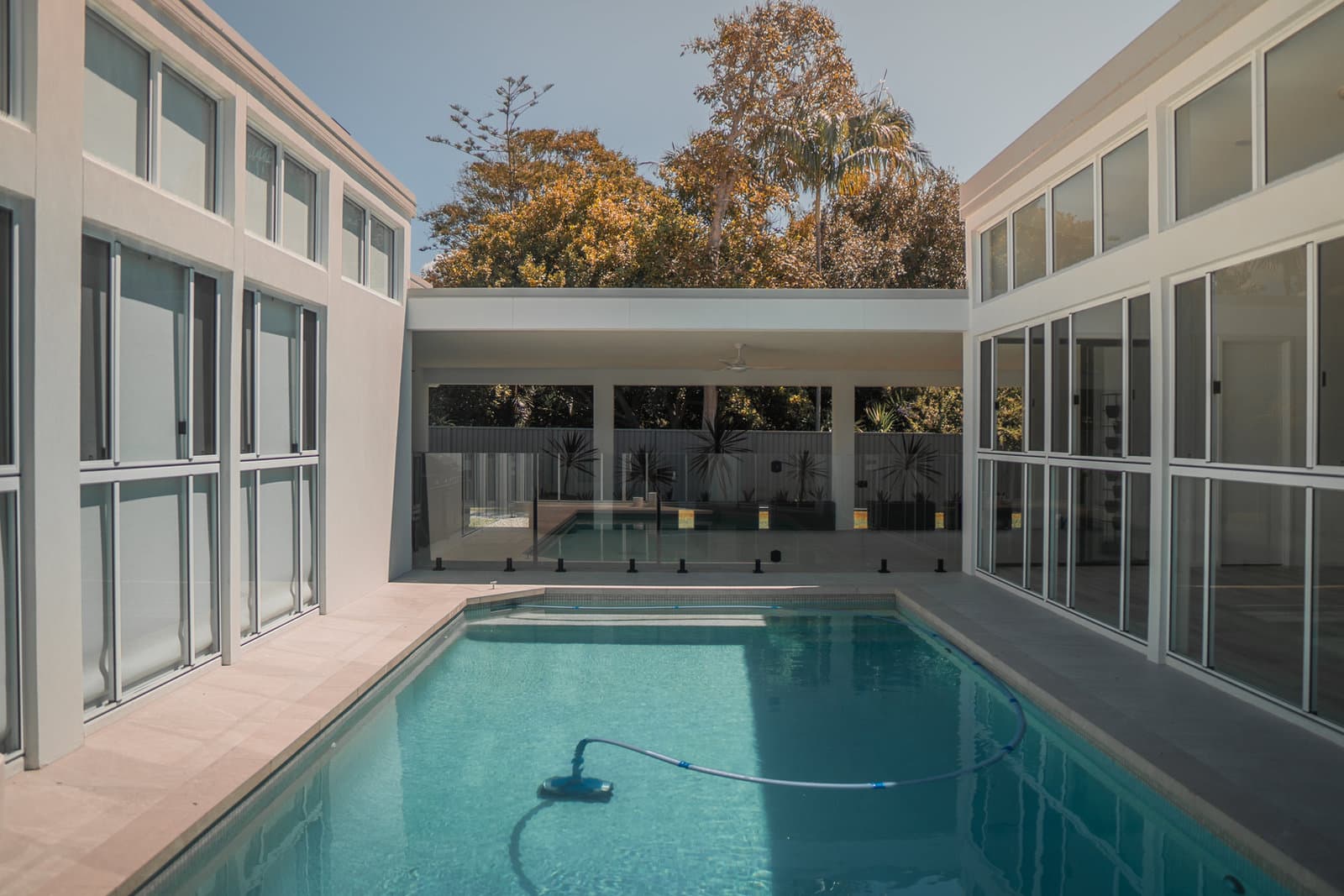 Swimming pool alongside a completed Qland home