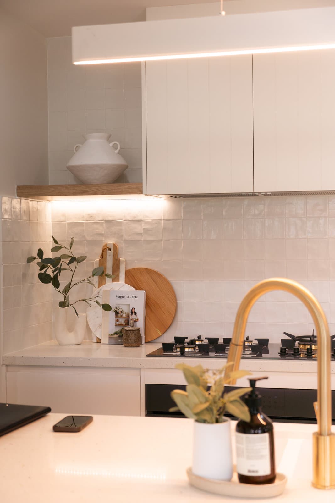 Kitchen benchtop detail with floor to ceiling tiling