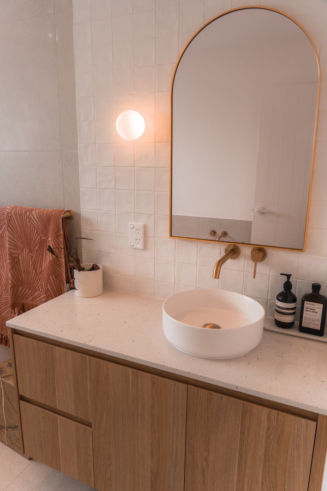 Bathroom with wall hung vanity and brass tapware